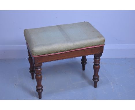 A Victorian mahogany commode, with removable over-stuffed seat, ceramic liner, on baluster supports and peg feet.