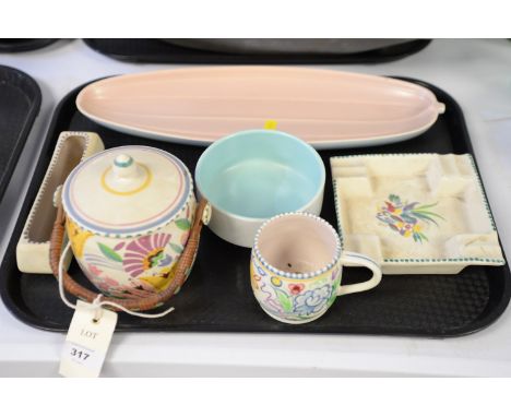 A collection of Poole pottery, including: a biscuit barrel; ashtray; mug; and dishes.