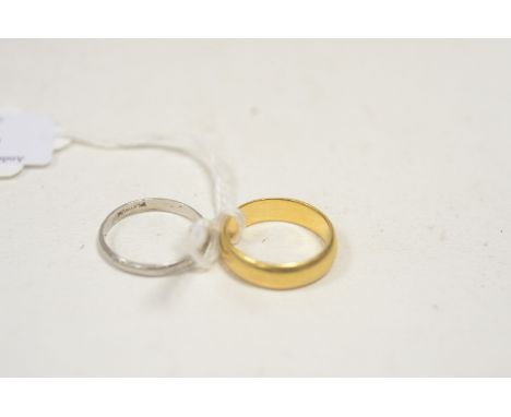 A 22ct. yellow gold wedding band, ring size P, 7.9g; together with a platinum wedding band, ring size P, 2.8g.