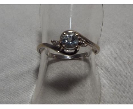 A lady's hallmarked 9 carat gold aquamarine and diamond ring, approximate weight 1.1 grams, size K and a half, boxed