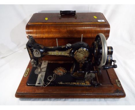 A good quality vintage sewing machine by "Jones's" in wooden carry case. 
