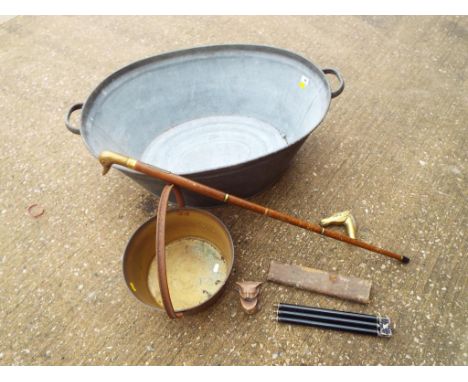 A galvanised tin bath, a brass jam pot, a brass ornamental head in the form of a cat, a nip walking stick, a further walking 