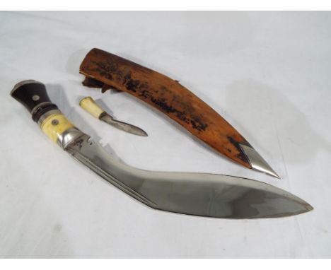 A bone and ebony handled Kukri and a  small  bone handled  knife in scabbard overall size of blade is 31cm overall size of kn