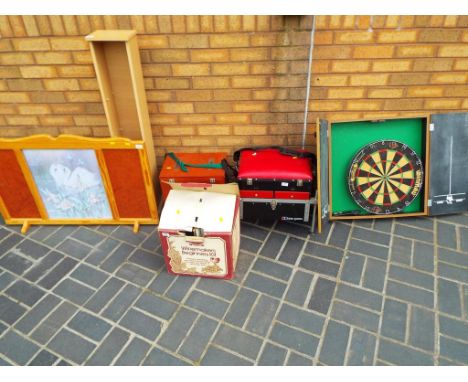 A good lot to include a CD stand, wooden storage box, fire guard, fishing seat and net, dartboard in case and beginners wine 