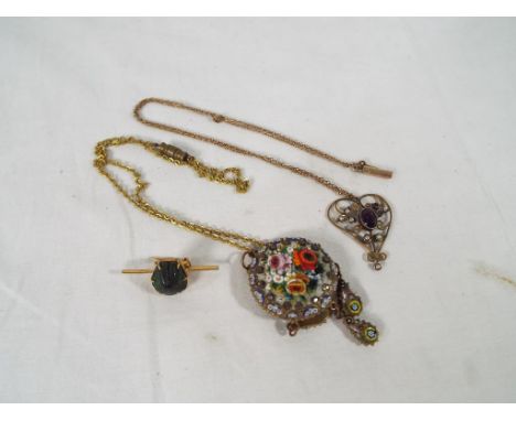 A small collection of jewellery to include a pendant and chain, scarab brooch and micro mosaic pendant 
