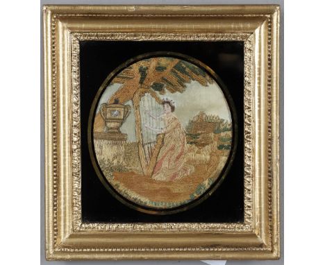 A REGENCY SILKWORK PICTURE. A REGENCY SILKWORK PICTURE. depicting a Lady playing a harp within a garden,  painted face and ar