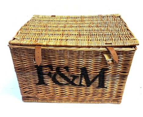 A RECTANGULAR WICKER PICNIC HAMPER by Fortnum &amp; Mason, with pair of carrying handles and leather fastening straps with 'F