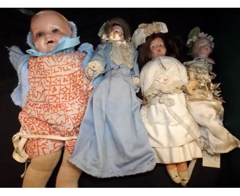 A collection of four vintage dolls including shoulder plate and one other porcelain head example.
