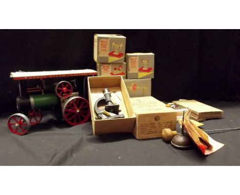 A Mamod steam traction engine together with accessories and a student microscope.