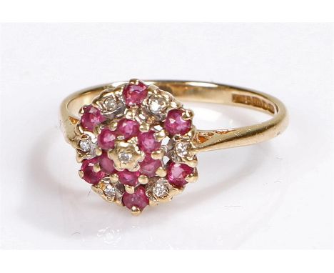 9 carat gold ruby and diamond set ring, in a flower head design, ring size J