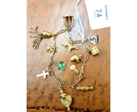 A gold charm bracelet, the fancy fetter and three link chain, suspending twelve charms including a gold and enamelled yacht a