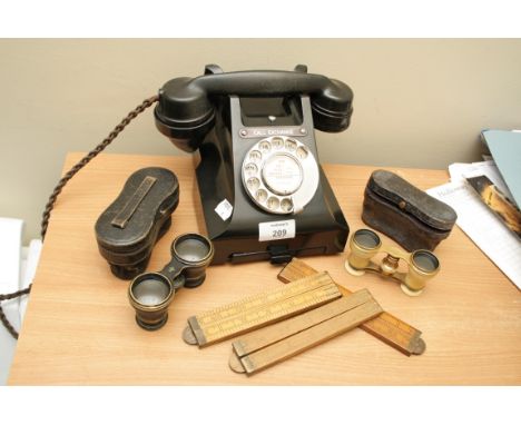 A vintage ebonite dial telephone with drawer bellow, ivory barrelled opera glasses and other items