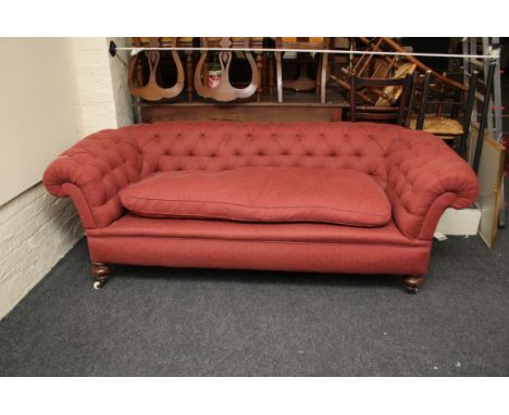 A Victorian three seat 'Chesterfield' settee with bun feet, 220cm wide