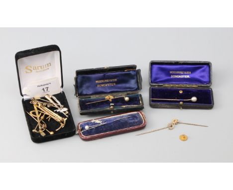 A 9ct gold bar brooch, in the form of a crop with an applied cast horse, a late Victorian seed pearl horseshoe stick pin, two