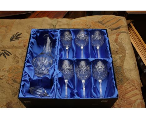 A presentation boxed cut crystal decanter and six stemmed wine glasses