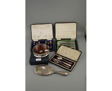 A cased Edwardian christening set, comprising a knife, fork and spoon, engraved decoration and mother-of-pearl handle to knif