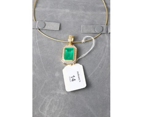 A substantial emerald and diamond pendant, the step cut, cut, cornered emerald in rub over mount, within a border of channel 