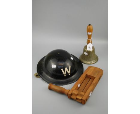 A collection of (1939/45) World War II ARP items, including a dated gas rattle, bell with hard wood handle and black ARP helm