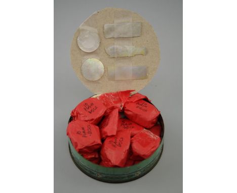 A collection of 19th century Chinese shaped Mother of Pearl gaming tokens in the form of fish discs and bars (141)