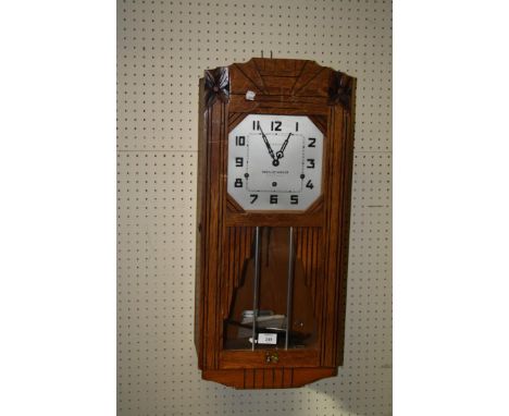 An oak cased Westminster chiming Art Deco wall clock. 68cm long