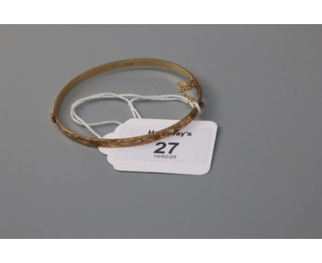 A 9ct gold bangle, engraved to front section 7.8g