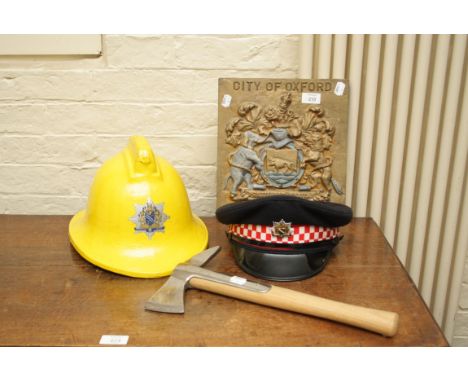 A collection of items relating to the city of Oxford fire service including a cast iron firestation plaque, presentation 'Bri