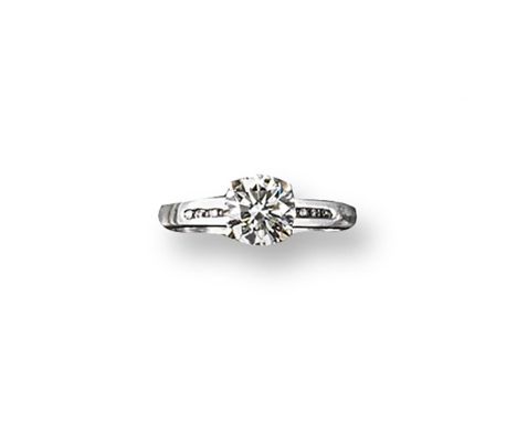 A diamond solitaire ring, the round brilliant-cut diamond weighs approximately 1.15 carats and is set in white gold with eigh