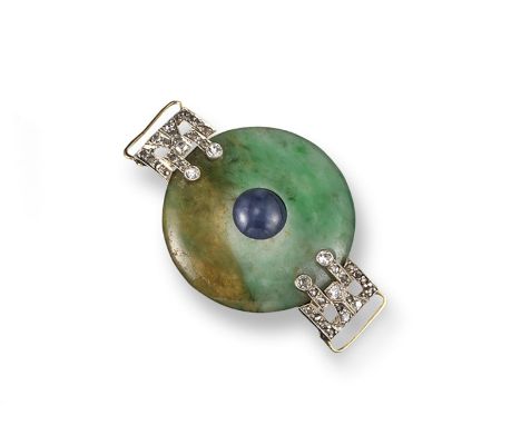 A circular jade disc centred with a blue chalcedony cabochon, the gold mount set with small diamonds. 2.8cm wide. Accompanied