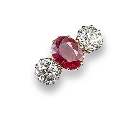 A ruby and diamond three stone ring, the oval-shaped ruby is set with two old circular-cut diamonds in 18ct yellow gold and p