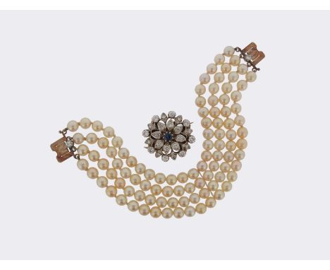 A four row cultured pearl bracelet, the pearls measure 6.0 - 6.5mm, the stylised flowerhead detachable clasp is centred with 