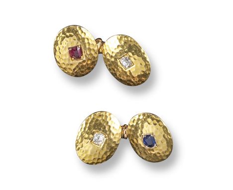 A pair of gem-set gold cufflinks, the oval links with beaten effect decoration and each set with a ruby, sapphire or diamond.