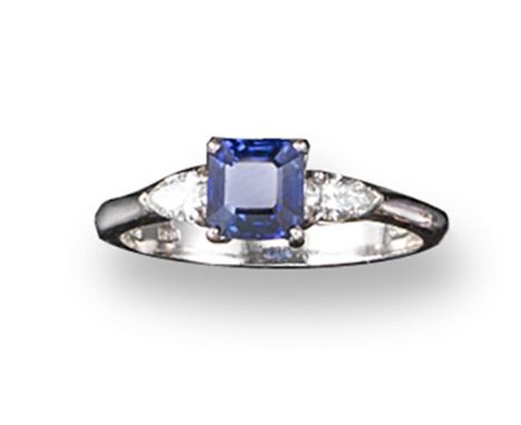 A sapphire and diamond three stone ring, the square shaped sapphire set with two pear shaped shoulder diamonds, in 18ct white