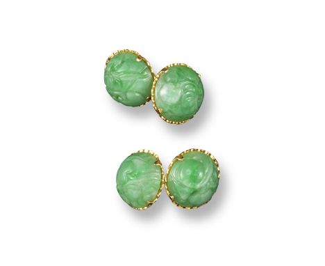 A pair of carved jade mounted gold cufflinks, each link mounted with a domed circular jade cabochon with engraved carved deco