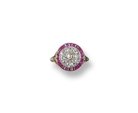 A diamond and ruby cluster ring, the old circular-cut diamond is set within a surround of smaller stones and millegrain-set w