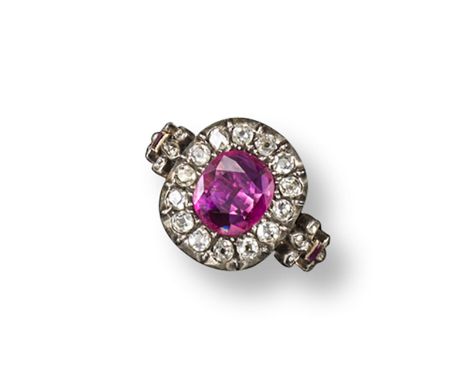 An early 19th century ruby and diamond cluster ring, the cushion-shaped ruby is set within a surround of cushion-shaped diamo