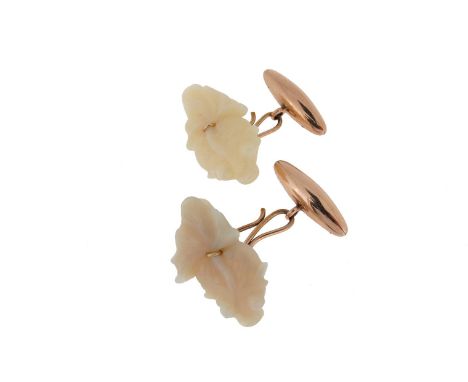 A pair of carved opal and gold mounted cufflinks cufflinks, the white opals designed as goldfish with gold torpedo links.