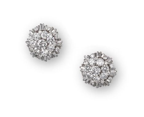 A pair of diamond cluster earrings by Boucheron, the centre round brilliant-cut diamond is set within a surround of seven sma