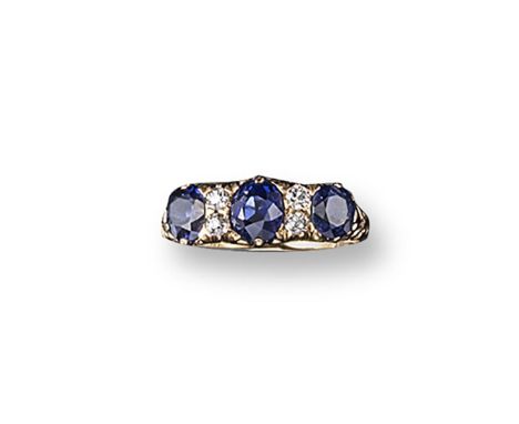 A sapphire and diamond seven stone ring, the three graduated oval-shaped sapphires are set with four smaller circular-cut dia