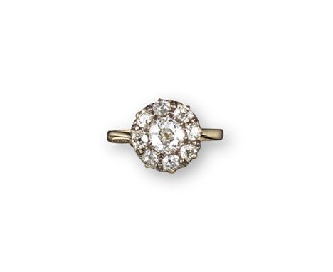 A diamond cluster ring, the central old cushion-cut diamond is set within a surround of smaller old cushion-cut diamonds in s