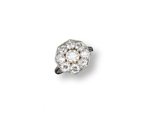 An early 20th century diamond cluster ring, the centre circular-cut diamond is millegrain set within a surround of eight smal