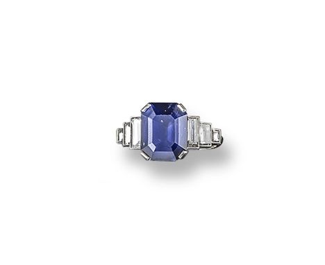 A sapphire and diamond ring, the emerald-cut sapphire weighs approximately 5.90cts and is set with six graduated baguette-sha