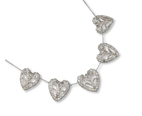 A necklace mounted with five slightly graduated diamond-set palmettes, each heart with a diamond set foliate centrepiece with