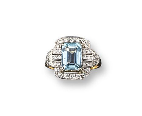 An aquamarine and diamond cluster ring, the emerald-cut aquamarine is set within a surround of circular-cut diamonds in plati