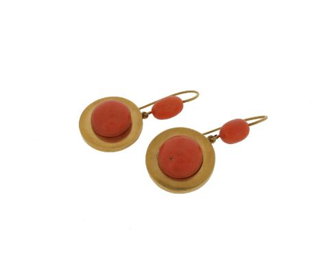 A pair of coral drop earrings, the circular button-shaped coral cabochons are set within a surround of yellow gold and suspen