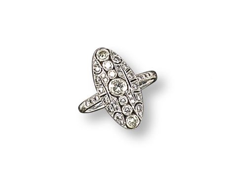 An early 20th century navette-shaped diamond cluster ring, millegrain-set with circular-cut diamonds in platinum. Size P.