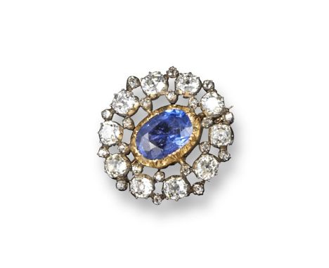 A late Victorian sapphire and diamond cluster brooch, centred with an oval-shaped sapphire within a surround of cushion-shape