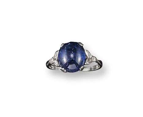 A cabochon sapphire ring, the oval-shaped cabochon sapphire is set with three marquise-shaped diamonds to each shoulder. Plat