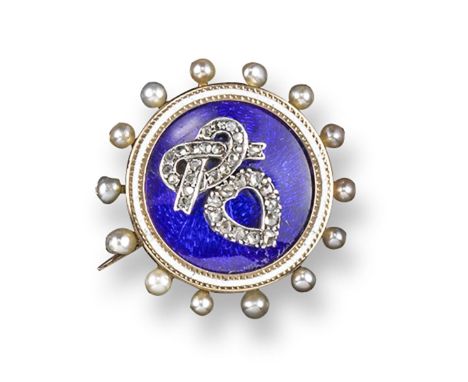 An Edwardian circular locket brooch, centred with a rose-cut diamond-set heart and lover's knot on blue enamel ground. White 