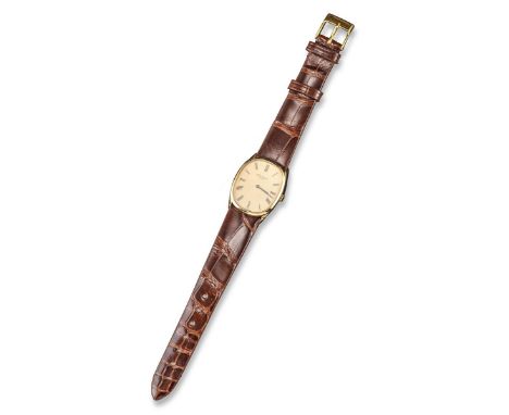 A yellow gold Ellipse wristwatch by Patek Philippe, signed gold textured dial with black Roman numerals and oval-shaped case.