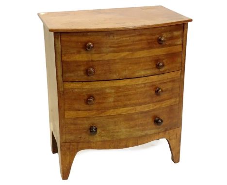 A mid 19thC mahogany bow fronted commode chest, the hinged lid enclosing a recess, the front with arrangement of four false d